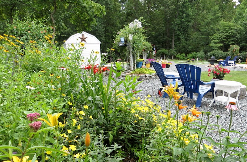 This beautiful garden features Milkweed, Daylilies, Oriental Lilies, and Coneflowers in a preaceful backyard retreat. Photo by our customer, Susan P.