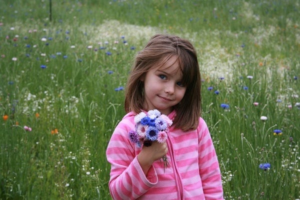 girl holding cornflower bouquet